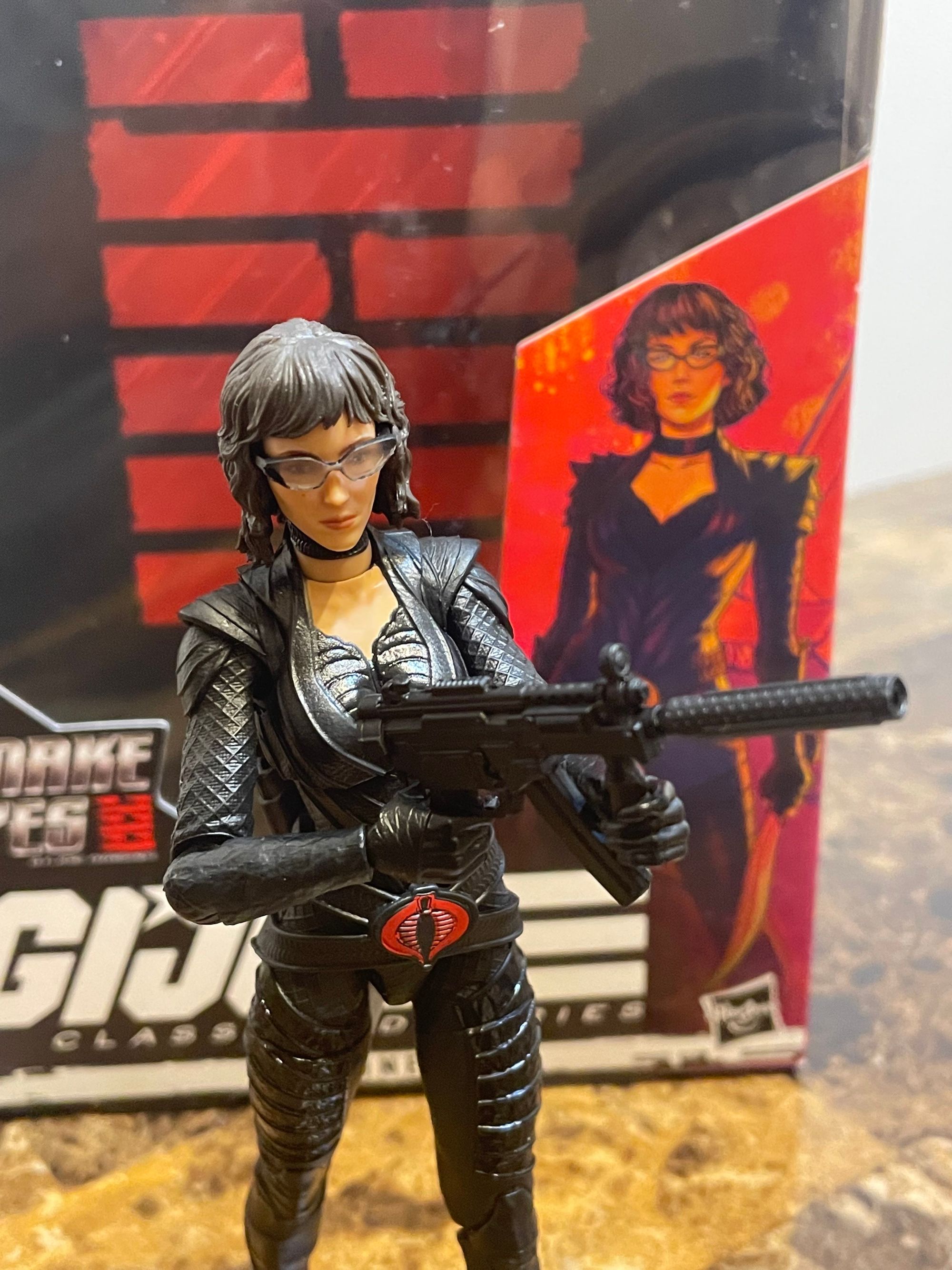 Toy of the Baroness, Cobra Intelligence head, wearing articulated black armor and wielding an MP5K with suppressor.